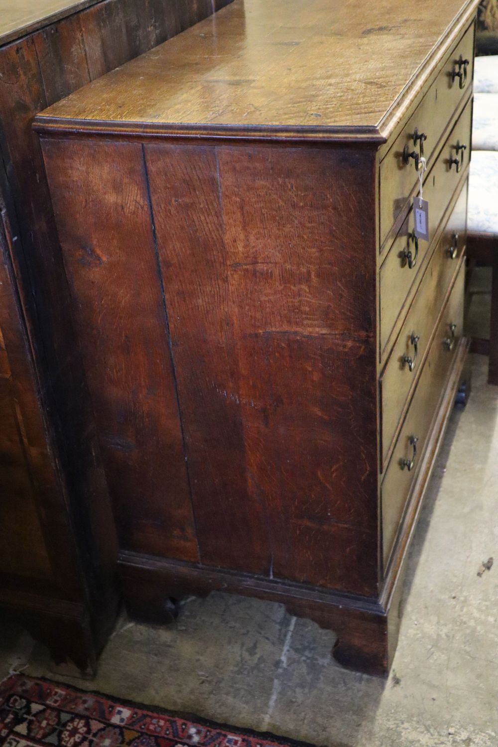 An 18th century oak chest fitted four graduated long drawers on shaped bracket feet, width 97cm depth 50cm height 96cm